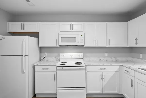 a kitchen with appliances a sink and cabinets