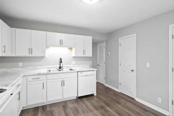 a kitchen with a sink a stove and cabinets