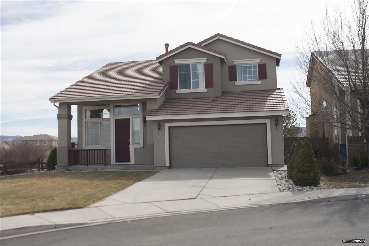 1690 Cattlemen Court Reno, NV 89521 - Photo 1 of 1 a front view of a house with a yard and garage