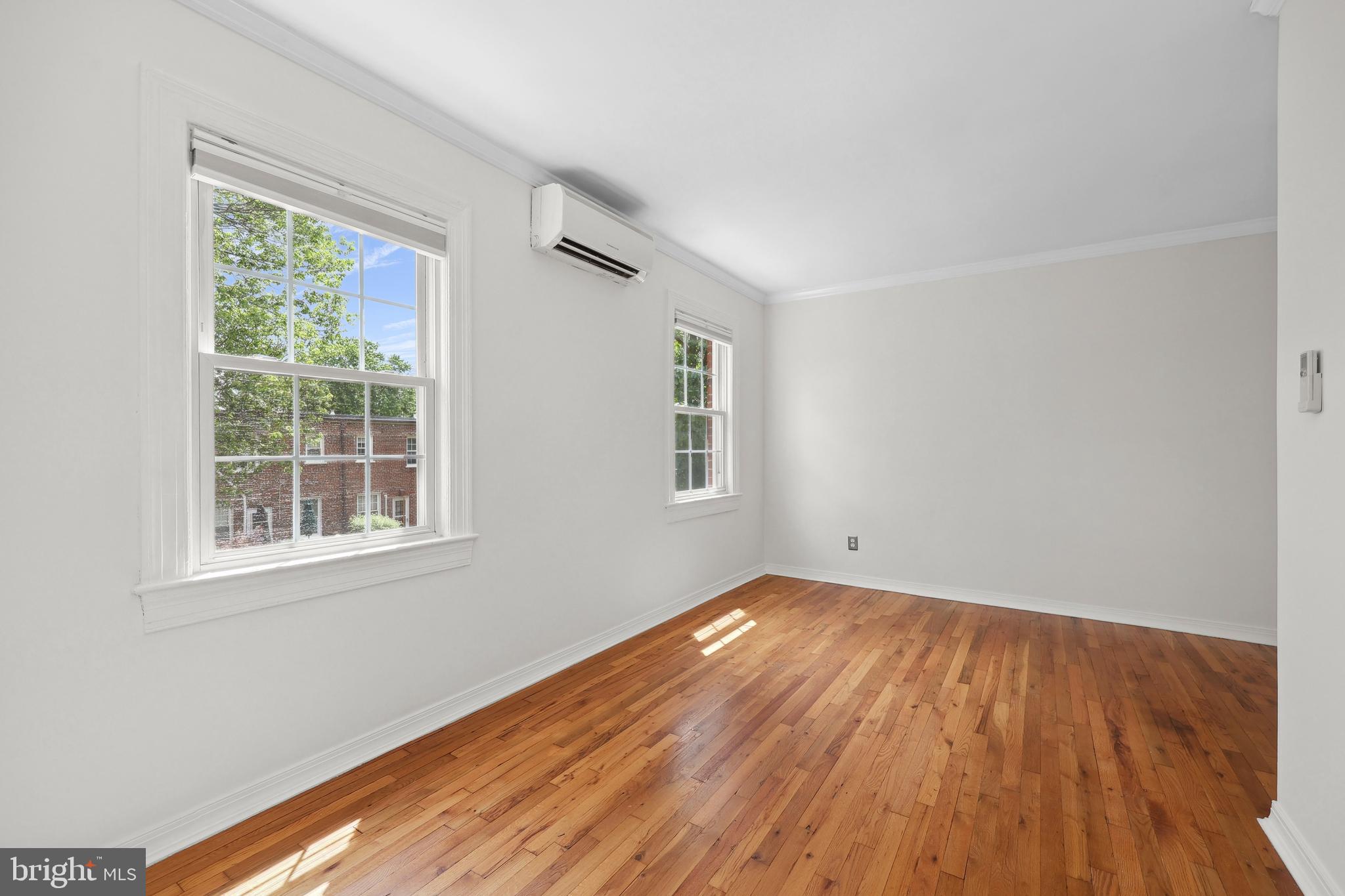 2600 16th Street South, Unit 711 Arlington, VA 22204 - Photo 11 of 27 a view of an empty room with wooden floor and a window