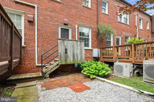 a view of a house with brick walls