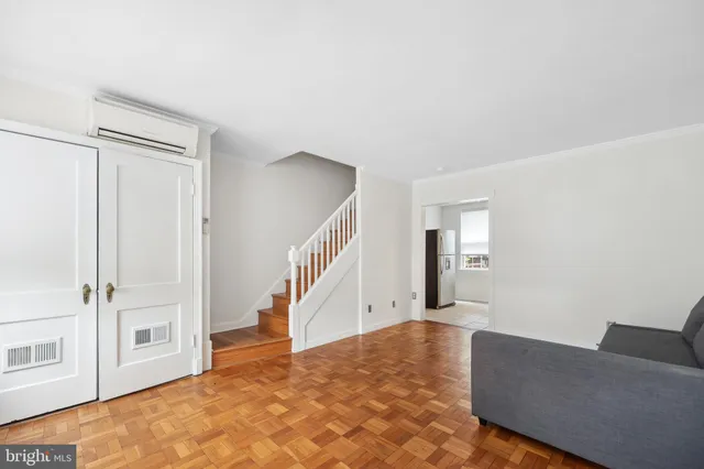 a view of a livingroom with wooden floor and stairs