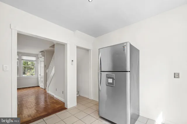 a view of a refrigerator in kitchen and livingroom with furniture