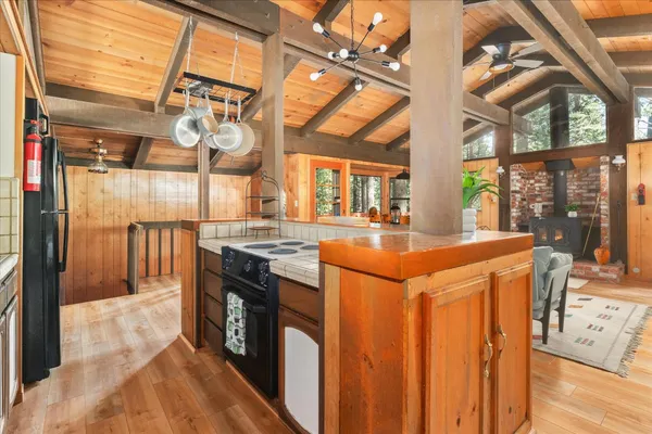 a kitchen with stainless steel appliances granite countertop a sink and cabinets with wooden floor