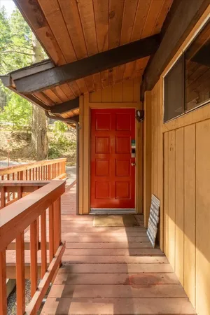 a living room with furniture a rug floor to ceiling windows and a flat screen tv