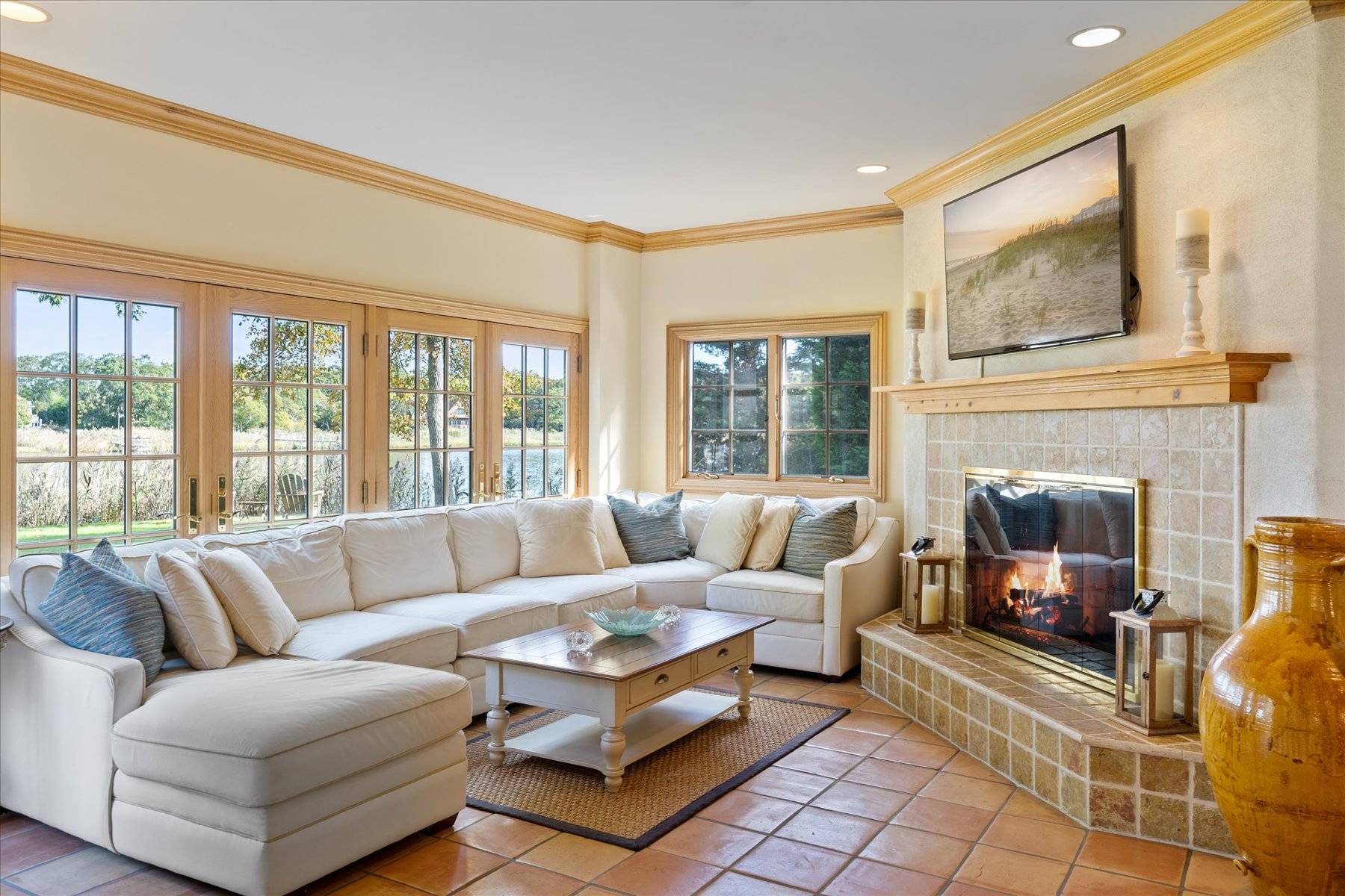25 Quantuck Bay Lane Westhampton Beach, NY 11978 - Photo 17 of 38 a living room with furniture large window and a fireplace