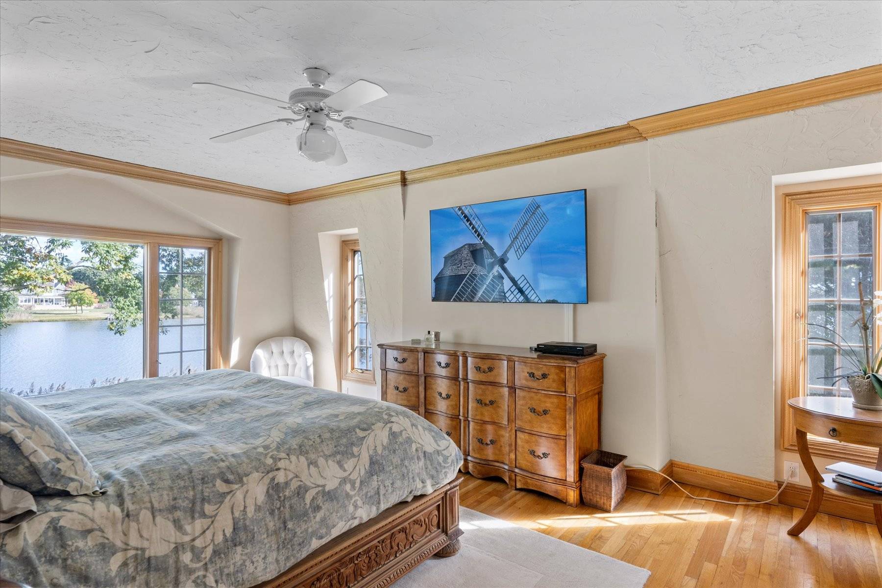 25 Quantuck Bay Lane Westhampton Beach, NY 11978 - Photo 25 of 38 a bedroom with a bed and a chandelier