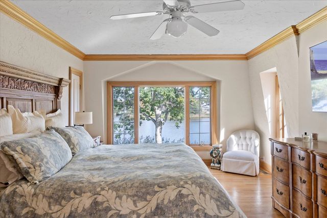 a bedroom with a large bed and a chandelier