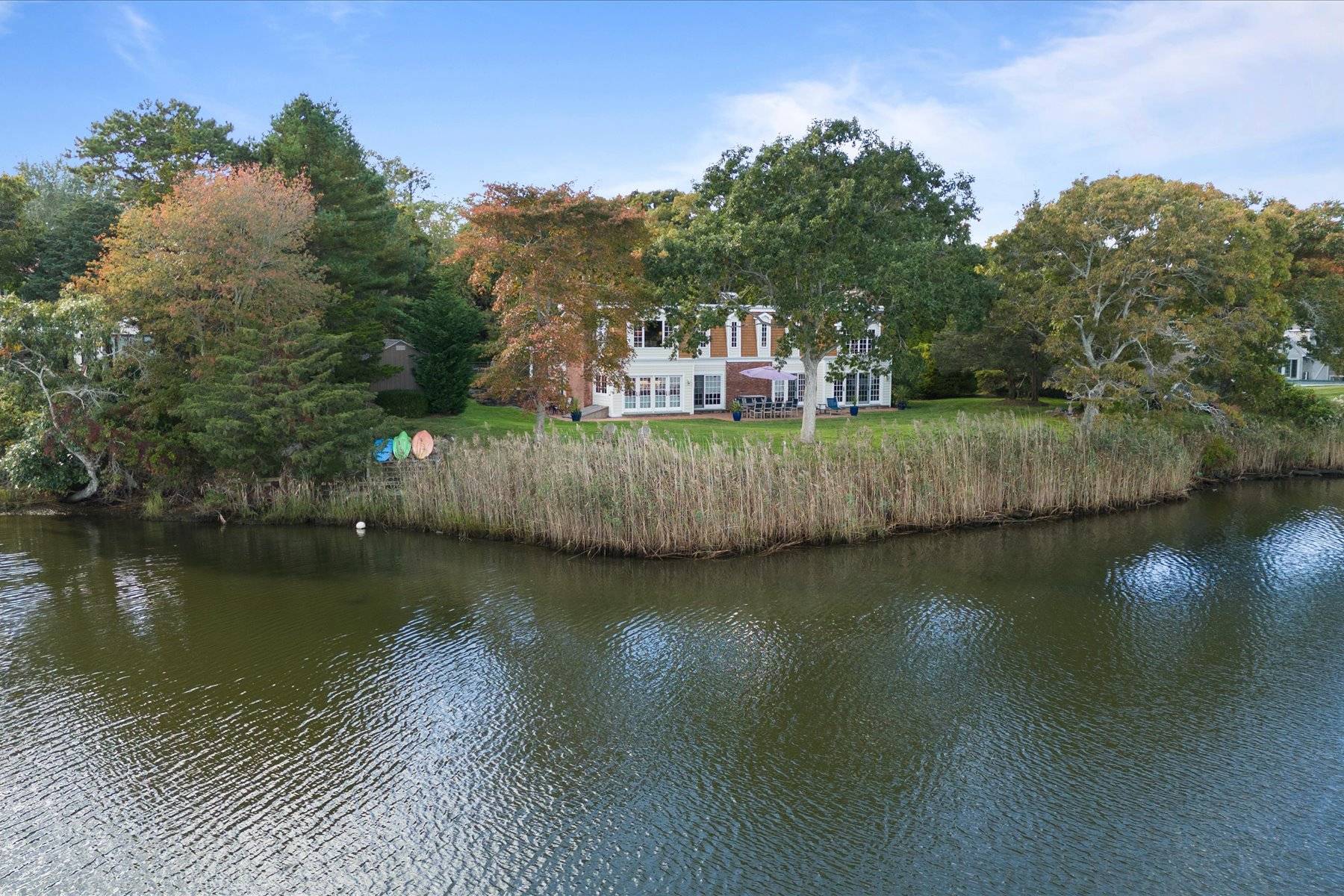 25 Quantuck Bay Lane Westhampton Beach, NY 11978 - Photo 37 of 38 a view of a lake with a house in the background