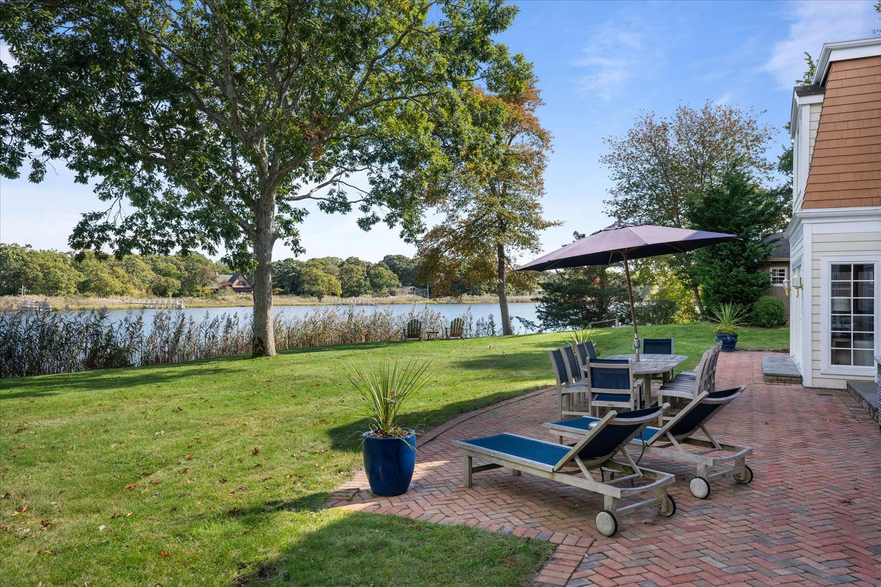 25 Quantuck Bay Lane Westhampton Beach, NY 11978 - Photo 4 of 38 a view of a backyard with chair and table