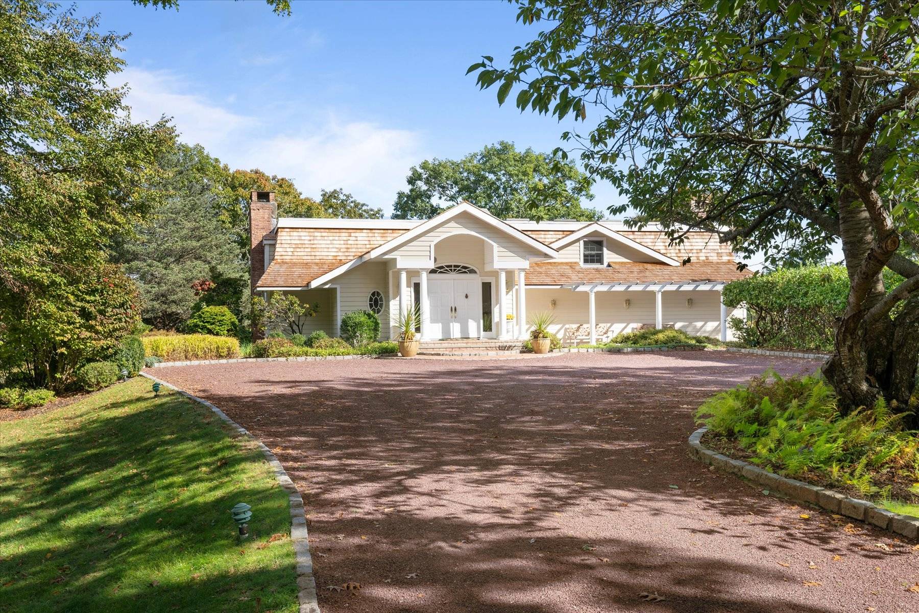 25 Quantuck Bay Lane Westhampton Beach, NY 11978 - Photo 7 of 38 a front view of a house with yard and green space