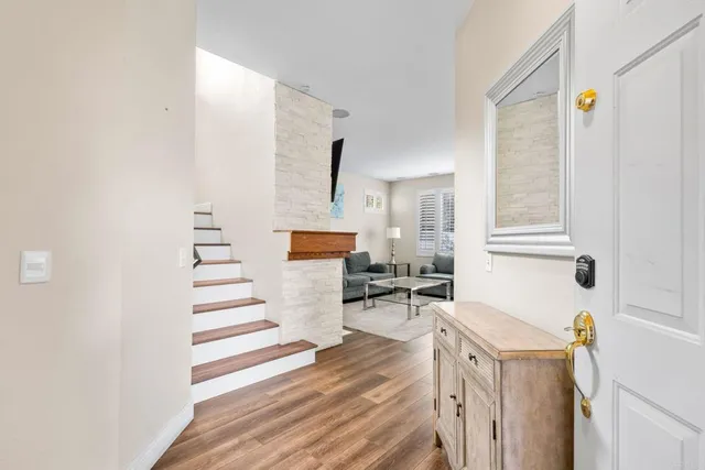 a view of a living room with furniture and wooden floor
