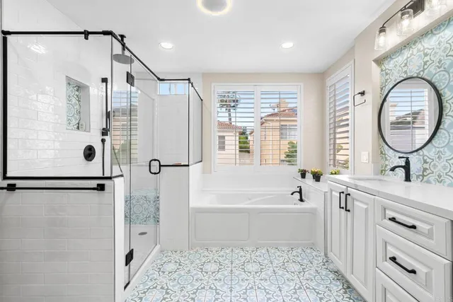 a bathroom with a bathtub shower sink and mirror