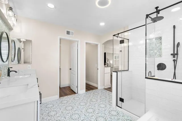 a bathroom with a shower sink and mirror