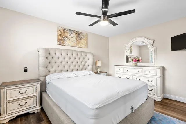 a bedroom with a bed and a tv on the dresser