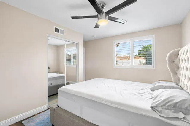 a bedroom with a large bed and a window