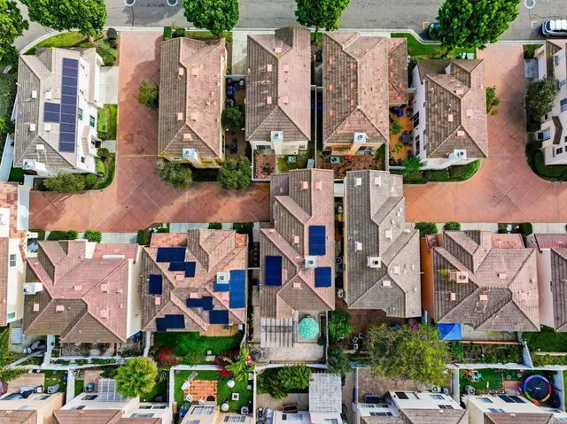 an aerial view of residential houses with outdoor space