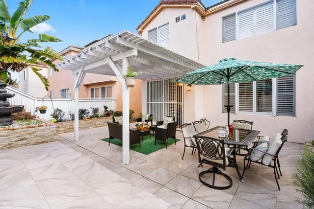 a view of a patio with table and chairs and potted plants