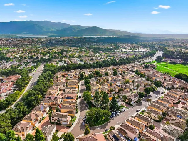 an aerial view of residential building and lake