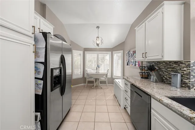 a kitchen with a white cabinets and appliances