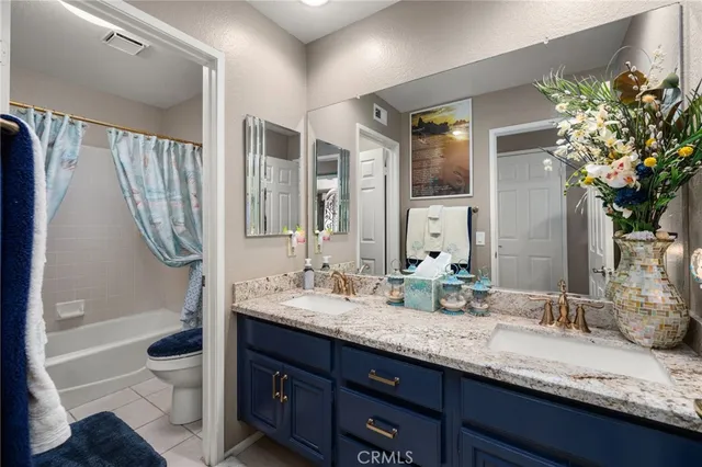 a bedroom with a bed and a dresser with wooden floor