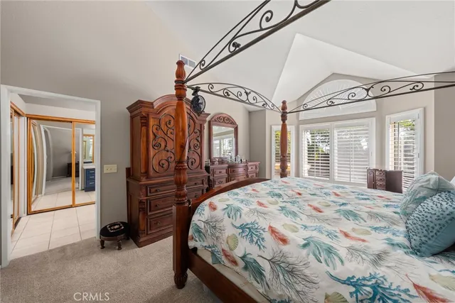 a large spacious bathroom with a granite countertop double vanity sink a mirror and a bathtub