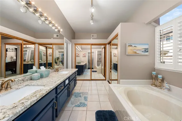 a bed room with a bed and a mirror