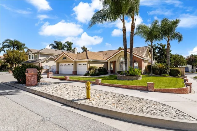 a view of a house with a swimming pool and a yard