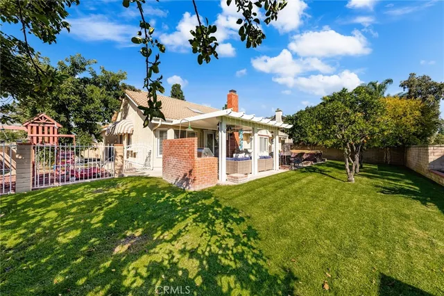 a living room with patio furniture and a garden