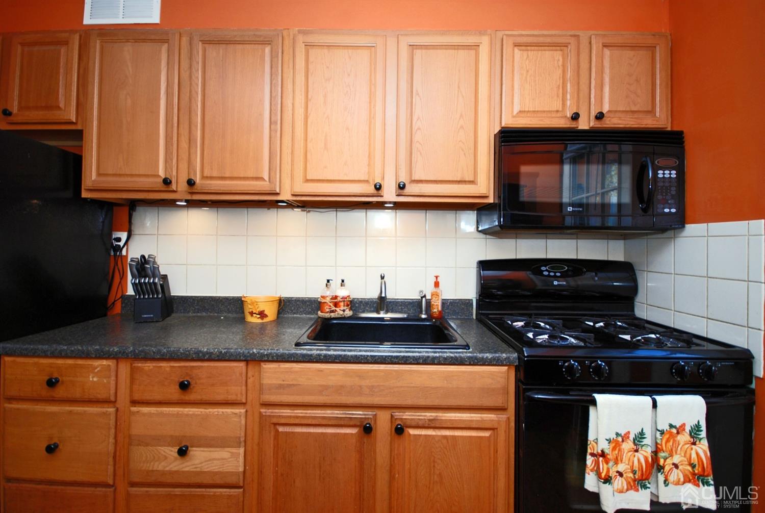 18 Crescent Road Edison, NJ 08817 - Photo 13 of 28 a kitchen with stainless steel appliances granite countertop a stove a microwave and cabinets