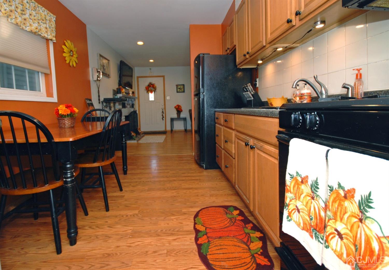 18 Crescent Road Edison, NJ 08817 - Photo 14 of 28 a kitchen with stainless steel appliances kitchen island granite countertop a table and chairs in it