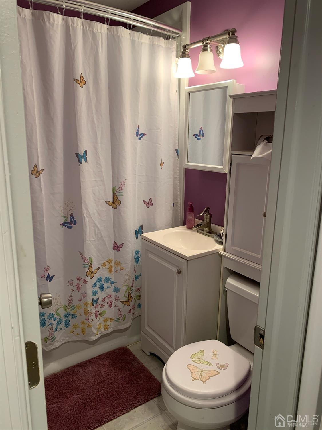 18 Crescent Road Edison, NJ 08817 - Photo 19 of 28 a bathroom with a sink a toilet a shower and a mirror