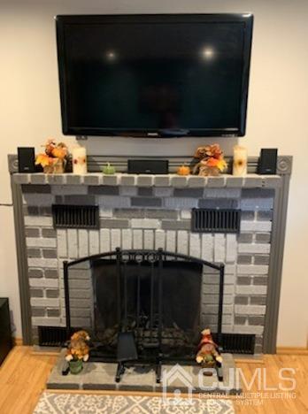 18 Crescent Road Edison, NJ 08817 - Photo 4 of 28 a room with fireplace and flat screen tv