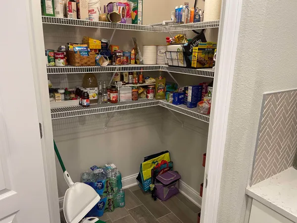 a room with water heater and white cabinet