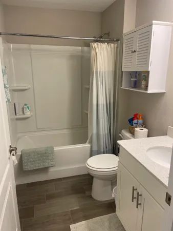a bathroom with a sink toilet and shower