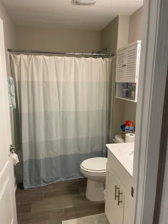 a bathroom with a toilet and a shower