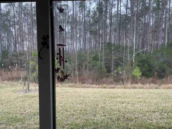a view of a glass door and a yard
