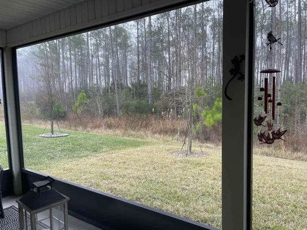a view of a room with a yard from a balcony