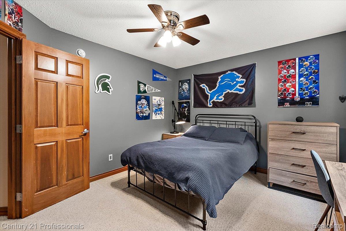 9867 Rainbow Ridge Drive Schoolcraft, MI 49087 - Photo 42 of 82 Bedroom featuring light-colored carpeting, a ceiling fan with integrated lighting, and a solid wood six-panel door