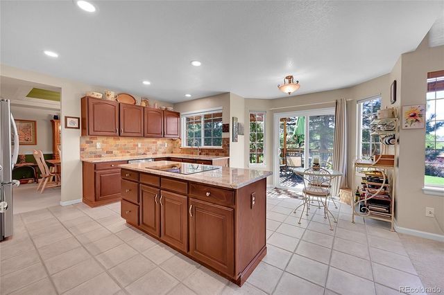 a kitchen with stainless steel appliances granite countertop a stove and cabinets