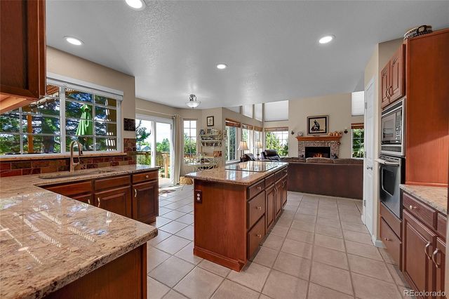 a kitchen with stainless steel appliances granite countertop sink stove top oven and cabinets