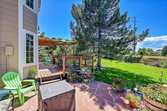 a view of a patio with couches table and chairs potted plants and palm trees