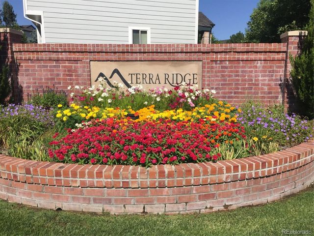 a street sign that is sitting in front of flowers