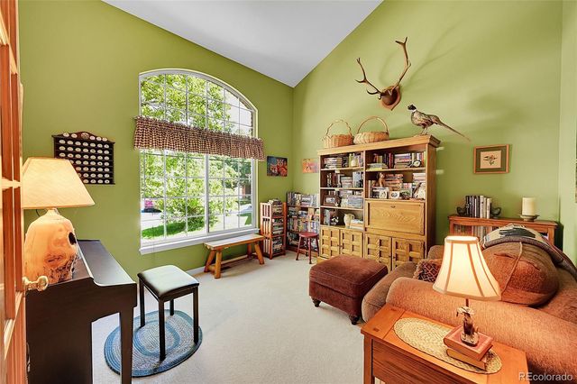 a bedroom with furniture and a large window