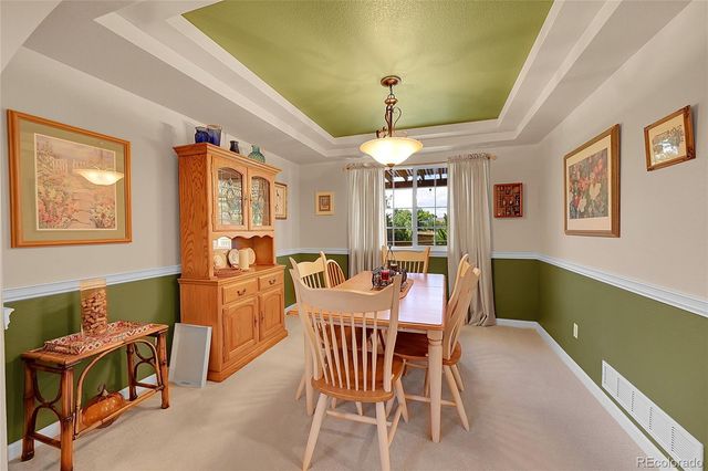 a dining room with furniture and chandelier kitchen view