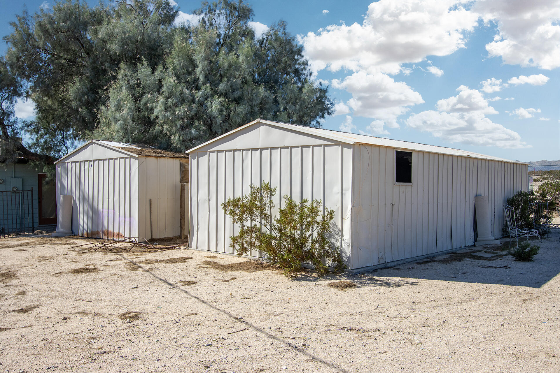 66621 Daisy Lane Joshua Tree, CA 92252 - Photo 18 of 53 a backyard of a house with garden and trees