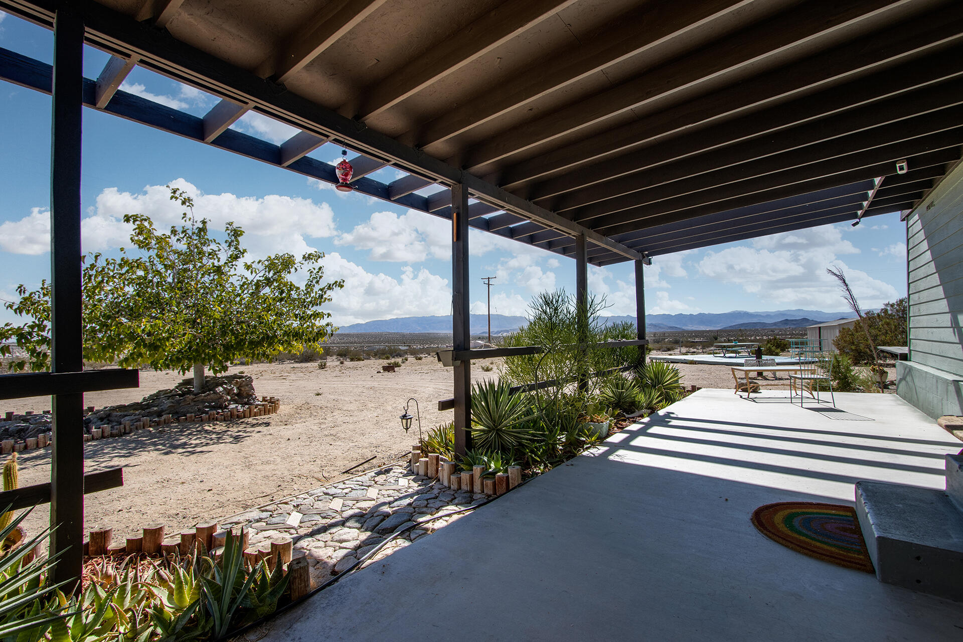66621 Daisy Lane Joshua Tree, CA 92252 - Photo 20 of 53 a view of a porch with furniture and yard