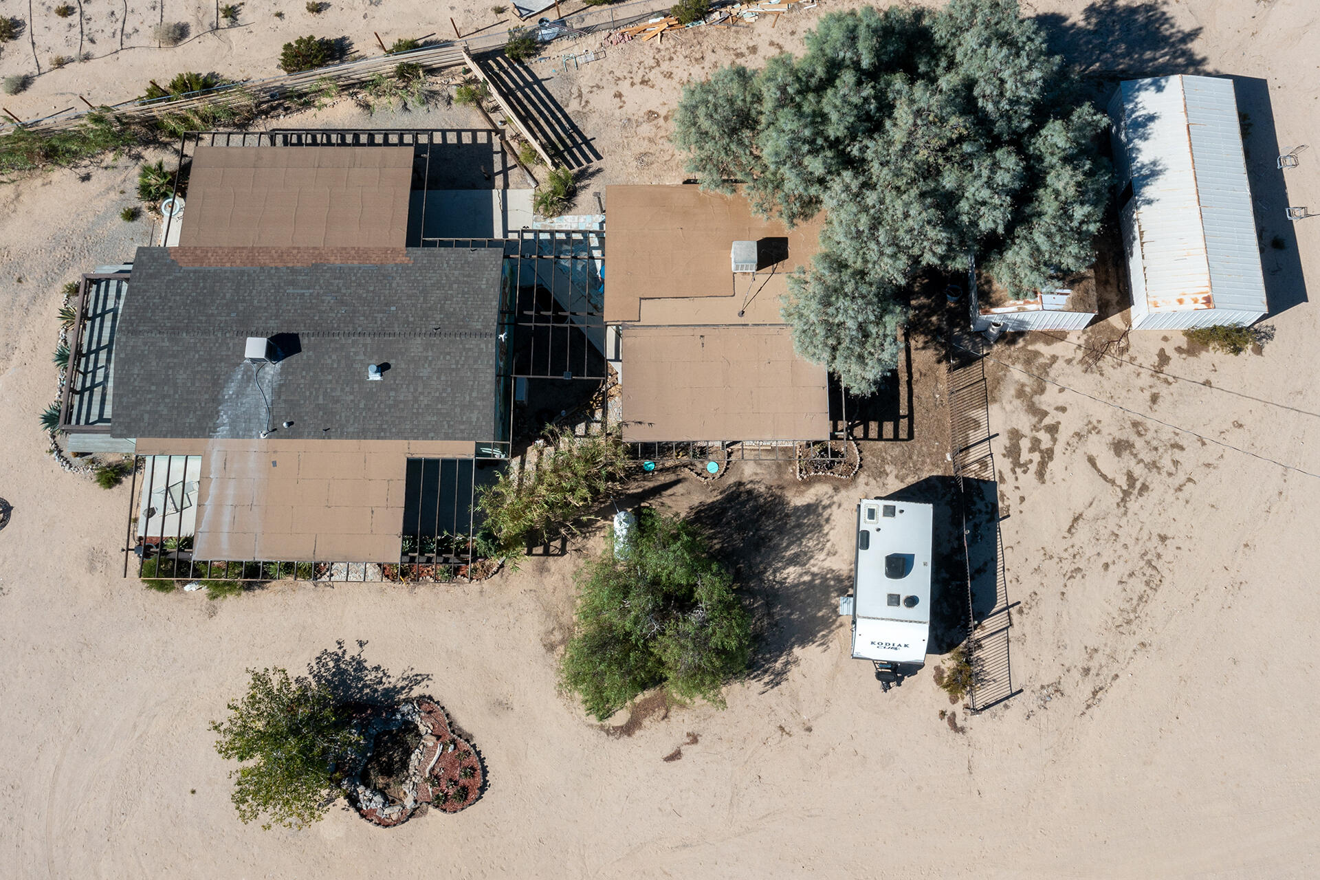 66621 Daisy Lane Joshua Tree, CA 92252 - Photo 7 of 53 an aerial view of houses with snow on the road