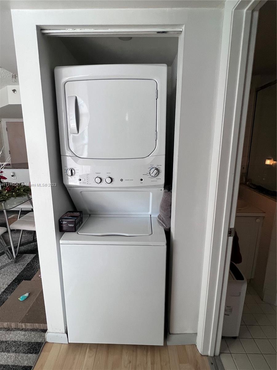8911 Collins Avenue, Unit 1004 Surfside, FL 33154 - Photo 19 of 20 a utility room with dryer and washer