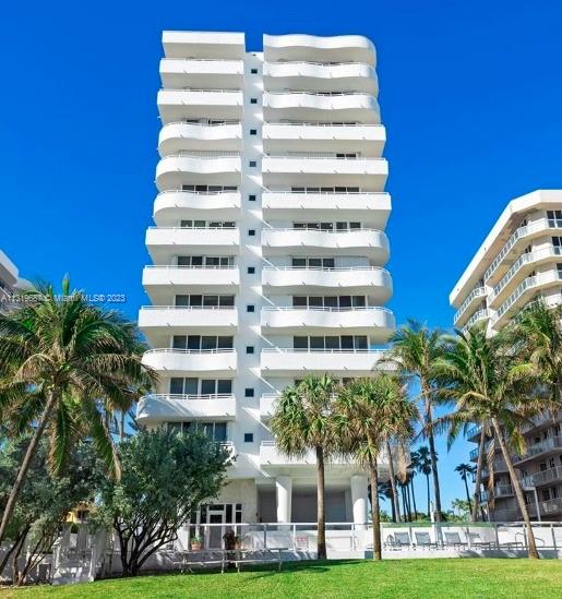 8911 Collins Avenue, Unit 1004 Surfside, FL 33154 - Photo 2 of 20 a front view of a multi story building with yard